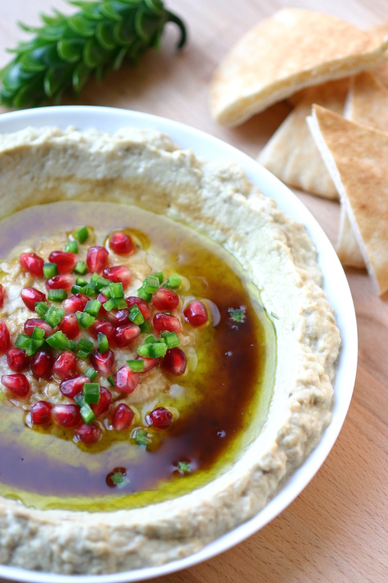 A 5-ingredient recipe for Mtabbal, a Middle Eastern eggplant spread finished with a drizzle of pomegranate molasses.