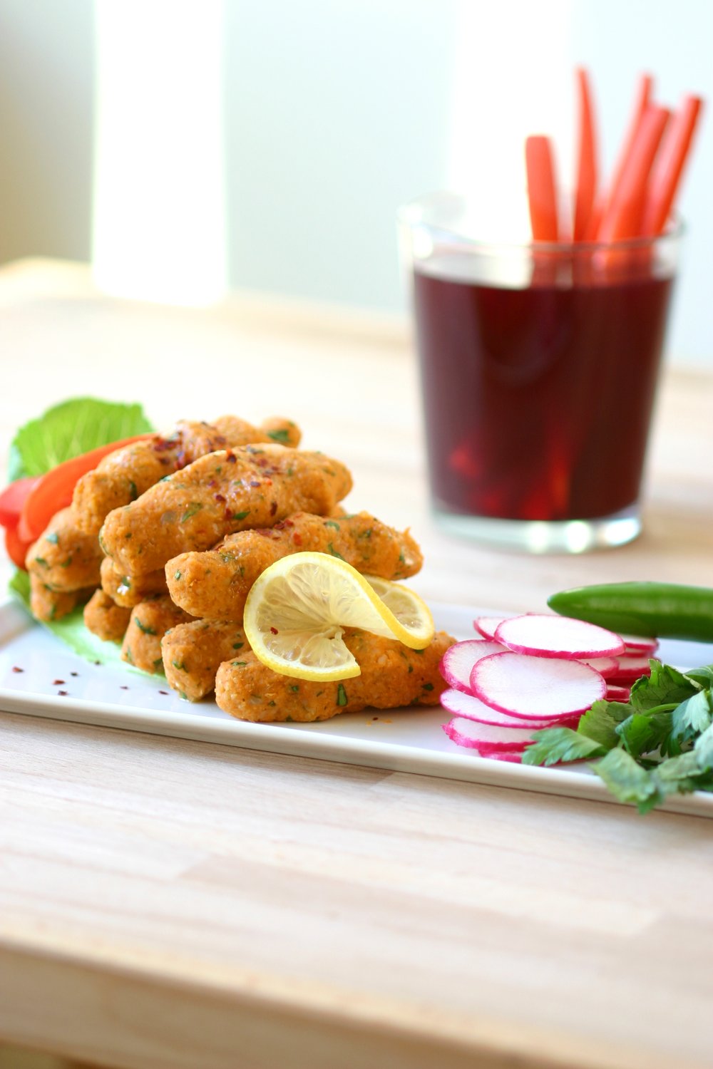 Creamy red lentils are simmered with bulgur wheat, then formed into addictive bite-sized, spicy and tangy fingers in this recipe for Red Lentil Köfte.