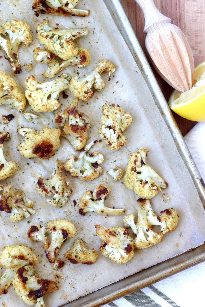 An easy recipe for Roasted Spiced Cauliflower with cumin, pepper, and mint and finished with a squeeze of lemon. Use as a side or stuff into sandwiches.