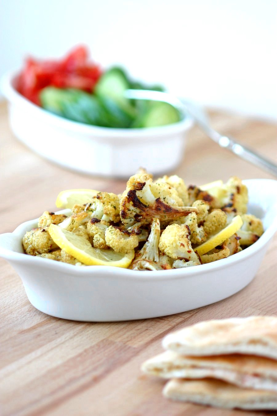 An easy recipe for Roasted Spiced Cauliflower with cumin, pepper, and mint and finished with a squeeze of lemon. Use as a side or stuff into sandwiches.