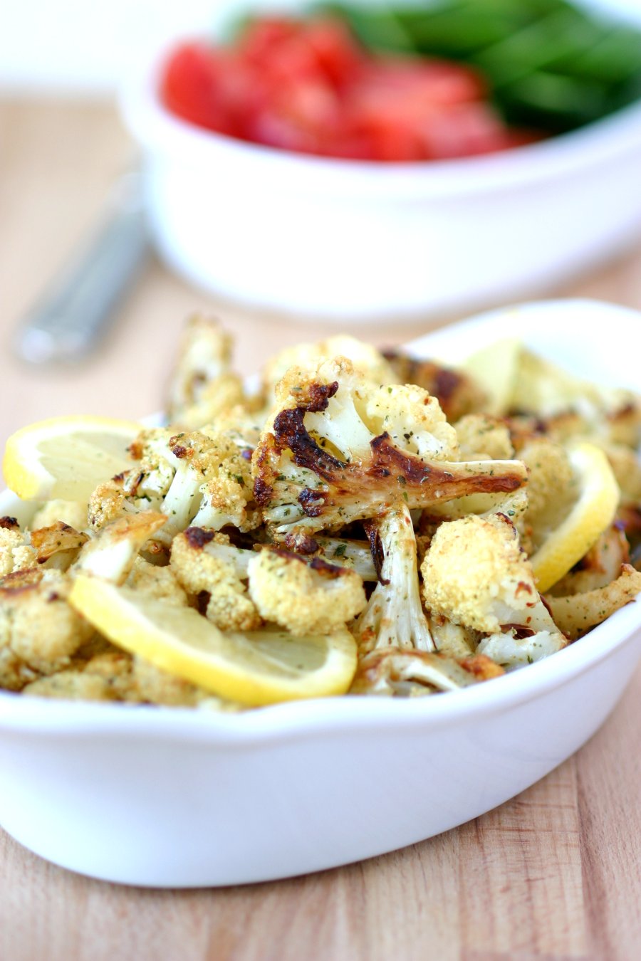 An easy recipe for Roasted Spiced Cauliflower with cumin, pepper, and mint and finished with a squeeze of lemon. Use as a side or stuff into sandwiches.