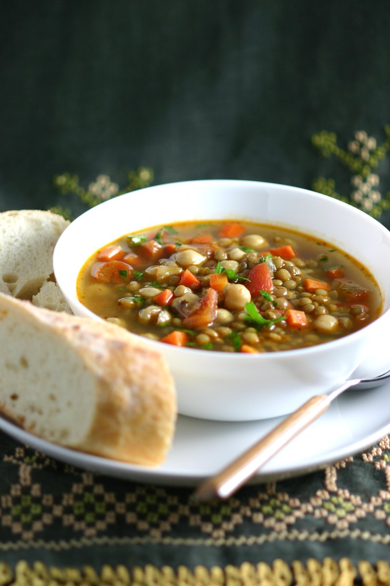 This Middle Eastern Green Lentil Soup features tender lentils, hearty chickpeas, and a spiced broth. Serve it as is or stir in some chopped greens.