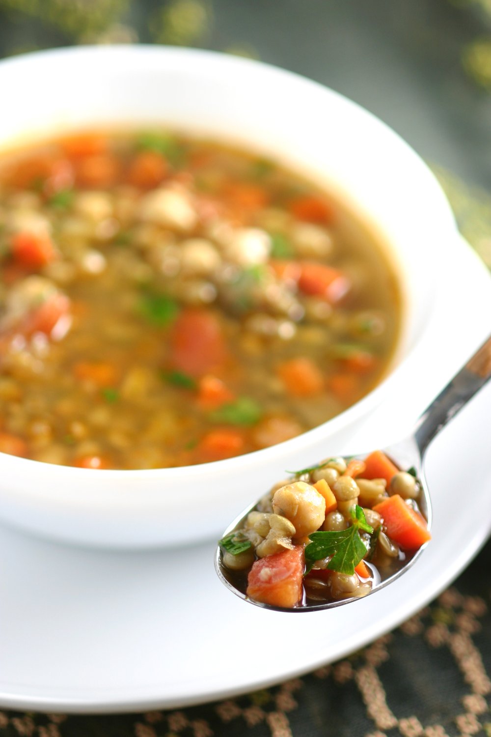 This Middle Eastern Green Lentil Soup features tender lentils, hearty chickpeas, and a spiced broth. Serve it as is or stir in some chopped greens.