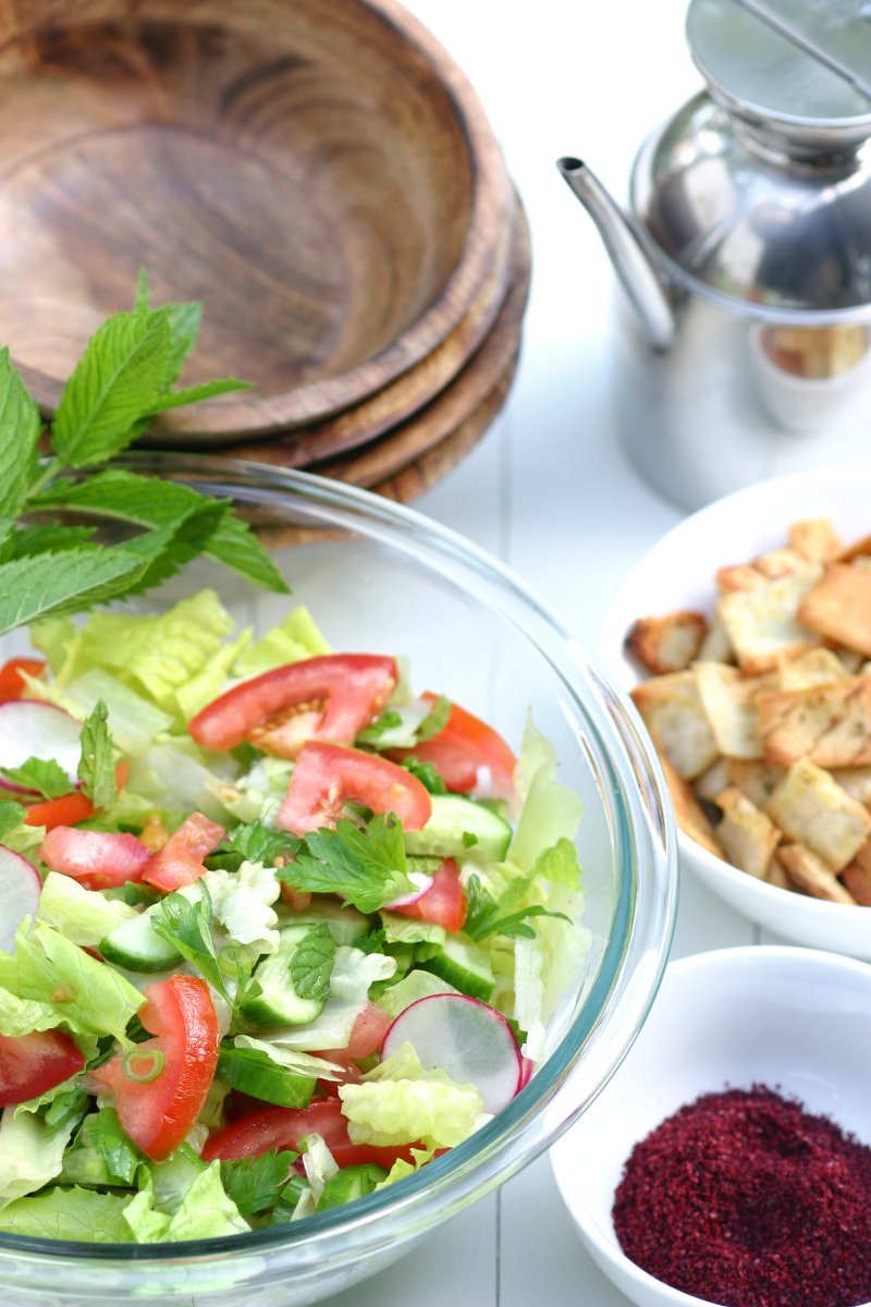 Think of Fattoush as the Middle Eastern version of the Italian panzanella salad--crisp veggies, fresh herbs, toasted pita bread, and a tangy sumac dressing.