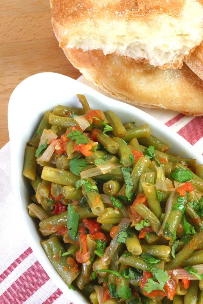 Middle Eastern Stewed Green Beans (Fasoolya bi Zayt) can be a side dish or even a light summer meal when served with lots of pita bread.