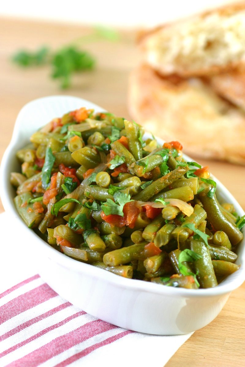 Middle Eastern Stewed Green Beans (Fasoolya bi Zayt) can be a side dish or even a light summer meal when served with lots of pita bread.