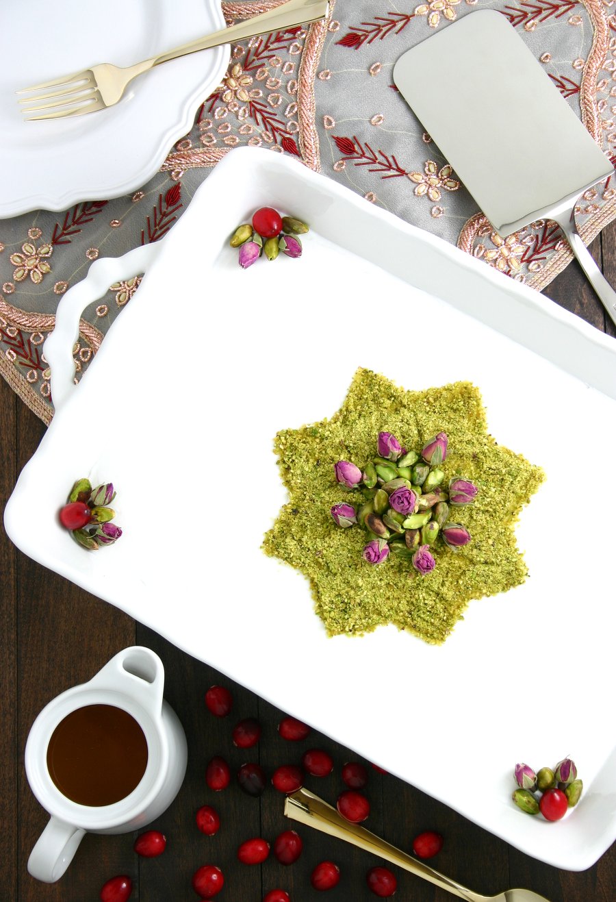 A very popular dessert throughout the Middle East, this Lebanese Semolina Pudding (Layali Lubnan) includes sweet-tart cranberries, thick coconut cream, ground pistachios, and a floral-scented syrup. This vegan recipe can be whipped up quickly, then it chills in the fridge until you are ready to dig in.