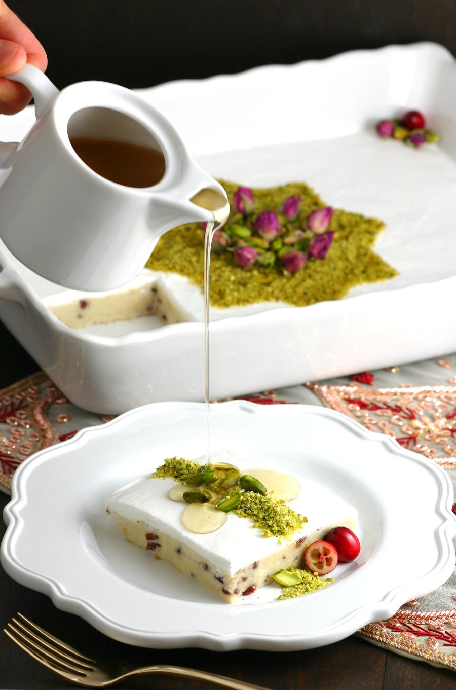 A very popular dessert throughout the Middle East, this Lebanese Semolina Pudding (Layali Lubnan) includes sweet-tart cranberries, thick coconut cream, ground pistachios, and a floral-scented syrup. This vegan recipe can be whipped up quickly, then it chills in the fridge until you are ready to dig in.