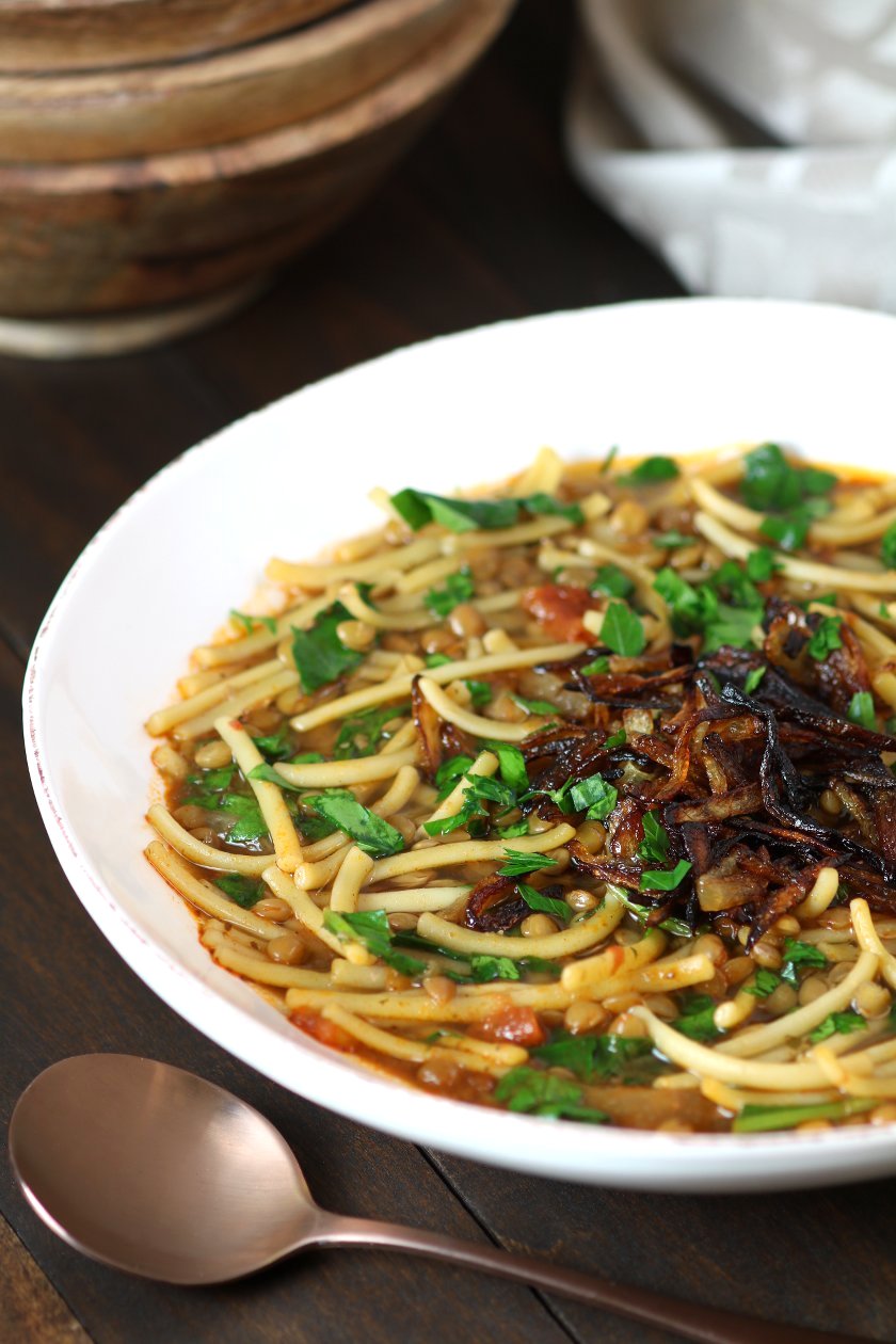 Lentils, noodles, carmelized onions, tomatoes, and a spiced broth come together to make this filling Lentil and Spinach Rashteh.