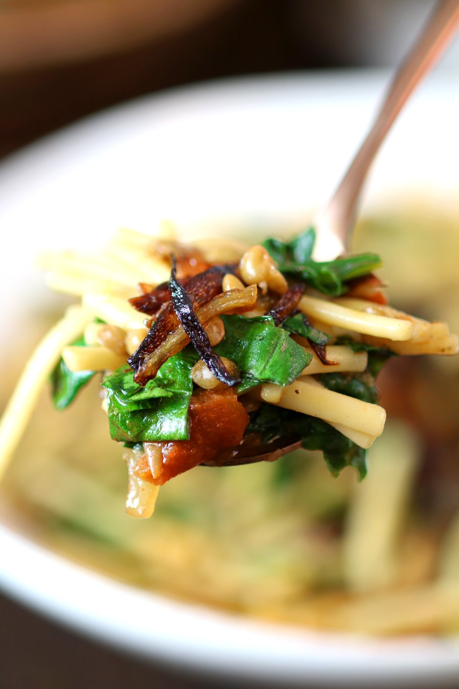 Lentils, noodles, carmelized onions, tomatoes, and a spiced broth come together to make this filling Lentil and Spinach Rashteh.