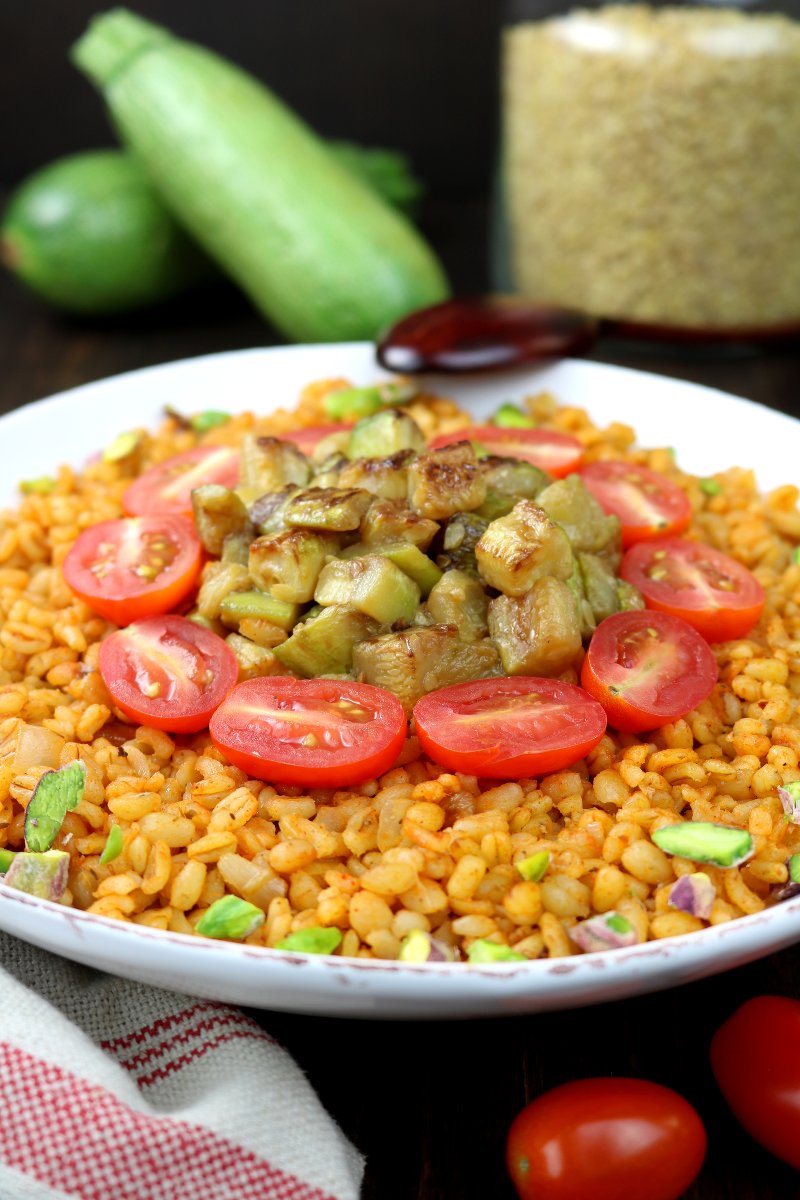 Whole grain bulgur, aromatic spices, and seared zucchini chunks are the core elements of this Middle Eastern-inspired Bulgur Wheat and Zucchini Bowl.