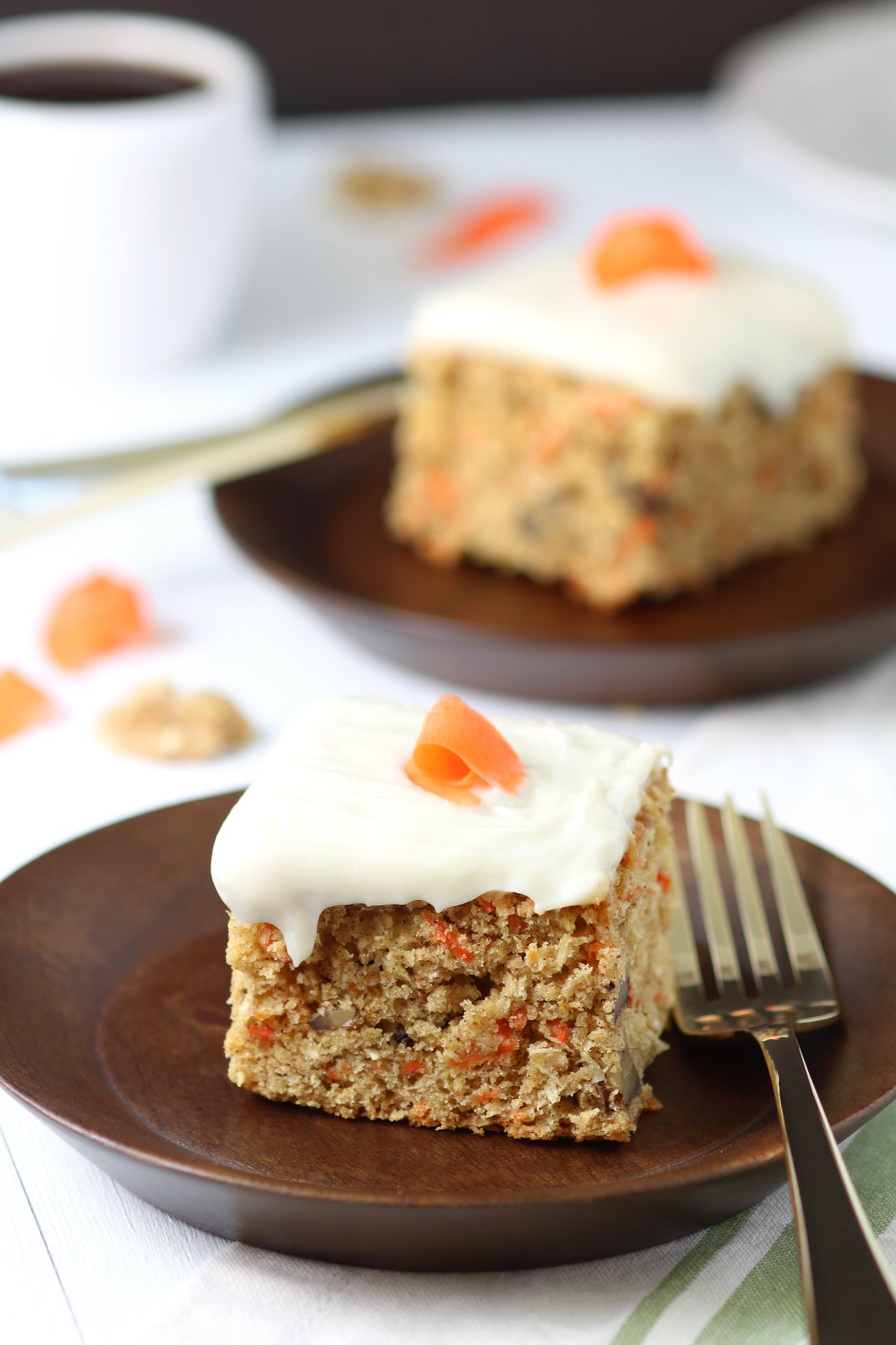 A versatile recipe featuring warm spices, coconut, and walnut to make this moist Vegan Carrot Cake with Cream Cheese Frosting irresistible.