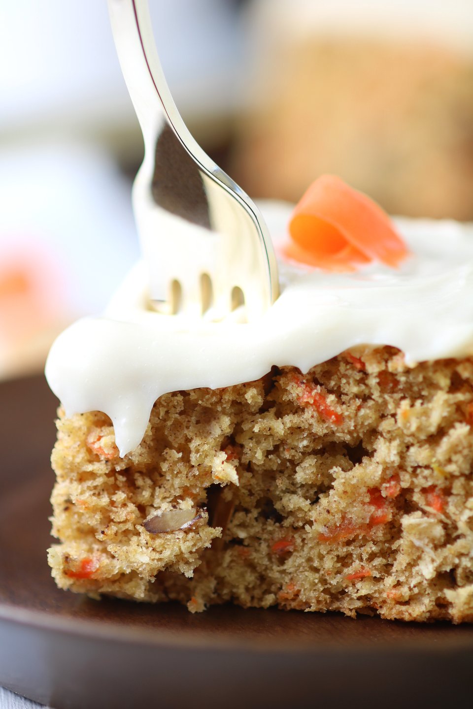 A versatile recipe featuring warm spices, coconut, and walnut to make this moist Vegan Carrot Cake with Cream Cheese Frosting irresistible.