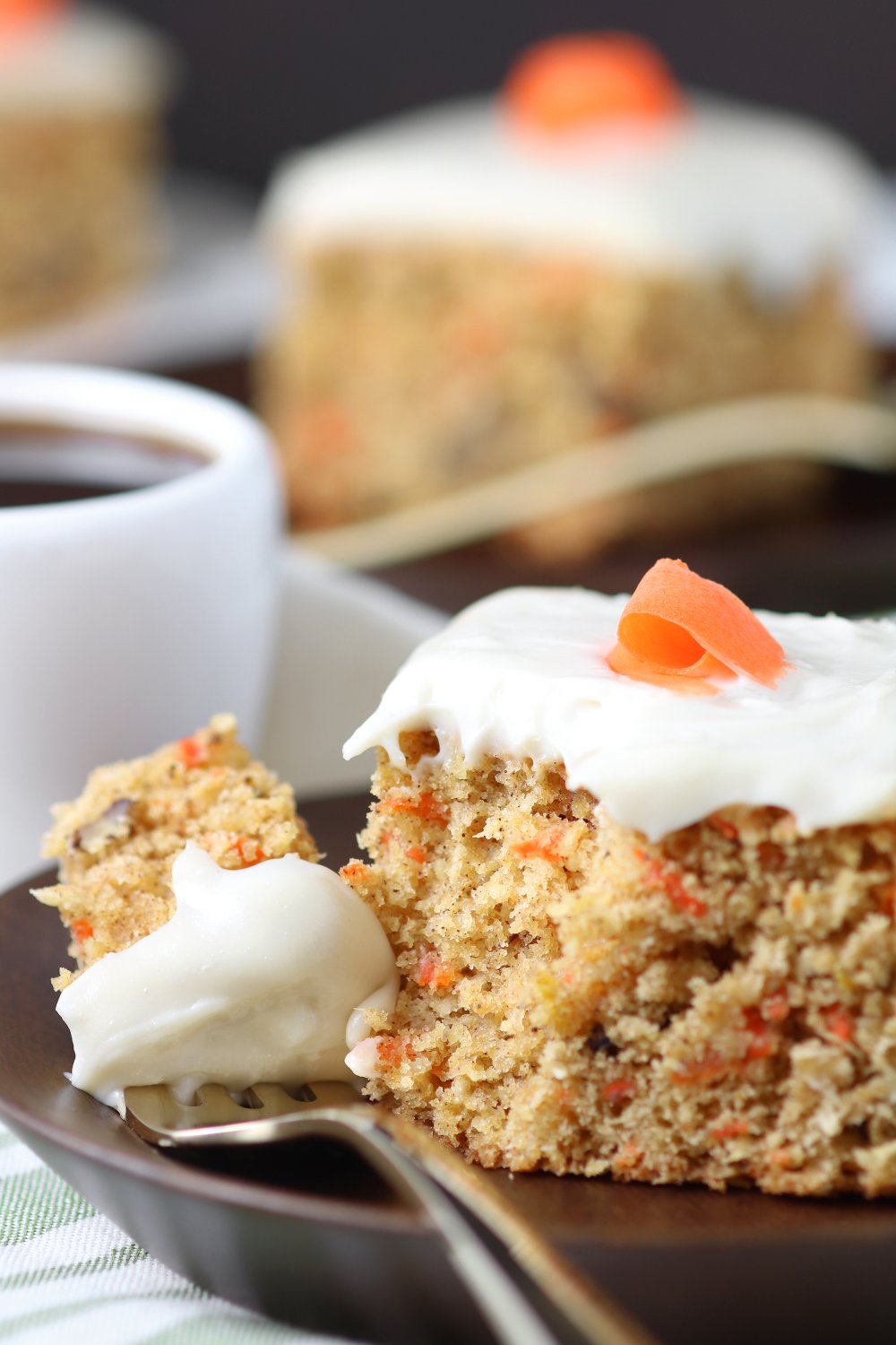 A versatile recipe featuring warm spices, coconut, and walnut to make this moist Vegan Carrot Cake with Cream Cheese Frosting irresistible.