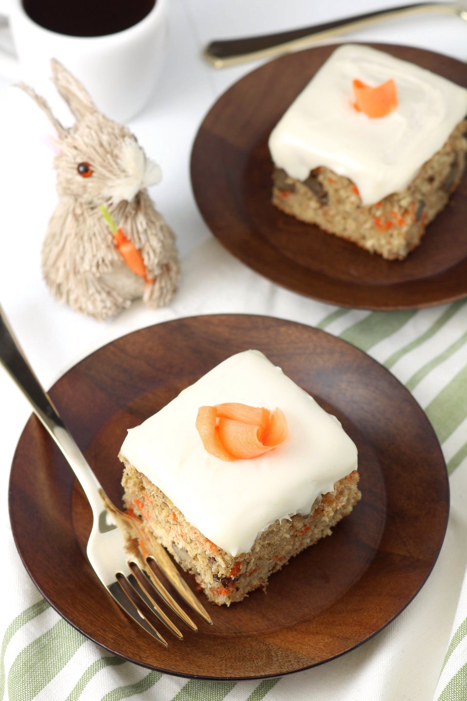 A versatile recipe featuring warm spices, coconut, and walnut to make this moist Vegan Carrot Cake with Cream Cheese Frosting irresistible.