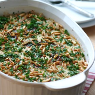 This recipe for Eggplant Fatteh, a Middle Eastern casserole dish, features toasted pita bread, a spiced tomato sauce, and a lemony tahini topping.