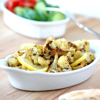 An easy recipe for Roasted Spiced Cauliflower with cumin, pepper, and mint and finished with a squeeze of lemon. Use as a side or stuff into sandwiches.