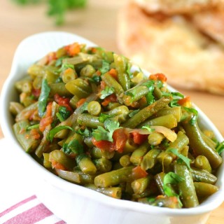 Middle Eastern Stewed Green Beans (Fasoolya bi Zayt) can be a side dish or even a light summer meal when served with lots of pita bread.